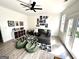 Cozy living room featuring a black leather sectional sofa, bean bag chairs, fun wall decor, and ample natural light at 3550 N Bogan Rd, Buford, GA 30519