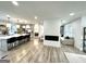 Open concept living room featuring a modern fireplace and seamless flow into the kitchen with bar stool seating at 3550 N Bogan Rd, Buford, GA 30519