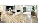 Open-concept living room featuring modern decor, a fireplace, a flat screen TV, and an open floor plan at 3550 N Bogan Rd, Buford, GA 30519