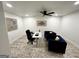 Bright home office featuring white walls, wood-look floors, ceiling fan, and modern furnishings at 3550 N Bogan Rd, Buford, GA 30519