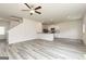 Open-concept living room flows into the kitchen with modern gray flooring and a ceiling fan at 279 Limestone Circle, Conyers, GA 30013