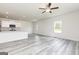 Spacious living room overlooking the kitchen with a ceiling fan and neutral walls at 279 Limestone Circle, Conyers, GA 30013
