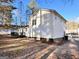 Back view of house with a deck, back door and wooded backyard at 473 Amy Blvd, Temple, GA 30179
