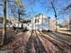 Back view of house with a deck and a tree filled backyard at 473 Amy Blvd, Temple, GA 30179