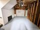 Unfinished basement with exposed ceiling, gray painted floor and white garage door at 473 Amy Blvd, Temple, GA 30179