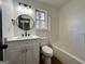 Bright bathroom with white vanity, black fixtures, and tub with shower, offering a clean design at 473 Amy Blvd, Temple, GA 30179