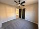 Bedroom with neutral walls, carpet, ceiling fan, and a view into an adjacent room at 473 Amy Blvd, Temple, GA 30179