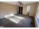 Bedroom featuring carpet, neutral walls, ceiling fan, and a view into an adjacent room at 473 Amy Blvd, Temple, GA 30179