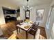 Open dining room with modern chandelier, white marble table, and dark blue kitchen in background at 473 Amy Blvd, Temple, GA 30179