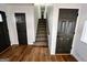 Neutral-colored entryway with hardwood floors, and black doors leading to different rooms at 473 Amy Blvd, Temple, GA 30179