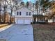 Two-story home with a two-car garage, front porch, and long driveway at 473 Amy Blvd, Temple, GA 30179