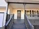 Close-up of the inviting covered front porch with gray wood floors and stairs at 473 Amy Blvd, Temple, GA 30179