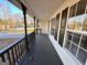 Inviting covered front porch with gray wood floors and stylish black railings at 473 Amy Blvd, Temple, GA 30179