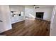 Open-concept living room featuring a stone fireplace and sleek hardwood floors at 473 Amy Blvd, Temple, GA 30179