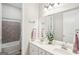 Bathroom with a double sink vanity and tub with tile surround at 175 Campaign Trl, Fayetteville, GA 30214