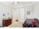 Comfortable Bedroom with soft carpet, wood dresser, and a teddy bear in the crib at 175 Campaign Trl, Fayetteville, GA 30214