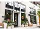 Exterior view of retail property featuring large windows, white brick, and potted plants, and inviting atmosphere at 175 Campaign Trl, Fayetteville, GA 30214