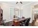 The office has a large desk, hardwood floors, and French doors leading to another room at 175 Campaign Trl, Fayetteville, GA 30214