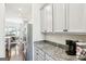 The kitchen has granite countertops, stainless steel appliances, and white cabinets at 175 Campaign Trl, Fayetteville, GA 30214