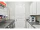 Laundry room with modern washer and dryer, storage shelves, and granite counters at 175 Campaign Trl, Fayetteville, GA 30214