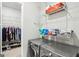 Well-equipped laundry room with shelving and modern washer and dryer at 175 Campaign Trl, Fayetteville, GA 30214