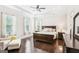 The main bedroom features tray ceilings, hardwood floors, natural light from windows, and ceiling fan at 175 Campaign Trl, Fayetteville, GA 30214