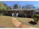 Charming single-story brick home featuring a walkway leading to the front entrance and a well-maintained lawn at 1800 Austin Dr, Decatur, GA 30032