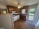 Functional kitchen featuring wood cabinets, a white appliance suite, and access to the backyard at 1800 Austin Dr, Decatur, GA 30032