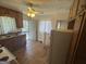 Functional kitchen featuring wood cabinets, a white appliance suite, and vinyl floors at 1800 Austin Dr, Decatur, GA 30032