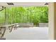 Expansive wooden back deck with built in seating overlooks a tranquil, wooded backyard at 145 Flat Creek Ct, Fayetteville, GA 30214