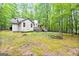 Exterior of home with a wooden deck and stairs, surrounded by trees and greenery at 145 Flat Creek Ct, Fayetteville, GA 30214