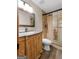 Renovated bathroom with wood vanity, stone countertop, and glass shower enclosure at 145 Flat Creek Ct, Fayetteville, GA 30214