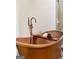Close up of a copper soaking tub with fixtures at 145 Flat Creek Ct, Fayetteville, GA 30214