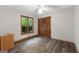 This bedroom features wood-look flooring, a ceiling fan, and a double door closet at 145 Flat Creek Ct, Fayetteville, GA 30214