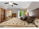 Bedroom featuring hardwood floors, a ceiling fan, and a door leading to a deck at 145 Flat Creek Ct, Fayetteville, GA 30214