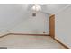 Spacious bonus room with vaulted ceiling, ceiling fan, and a classic wood door at 145 Flat Creek Ct, Fayetteville, GA 30214