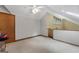 This bonus room has natural light and includes carpet, wooden trim, and ceiling fan at 145 Flat Creek Ct, Fayetteville, GA 30214