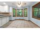 Eat-in kitchen boasting ceramic tile floor, ceiling fan, and wooded view from bay window at 145 Flat Creek Ct, Fayetteville, GA 30214