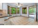 Eat-in kitchen features ceramic tile floors, wood-framed windows, and easy access to screened porch at 145 Flat Creek Ct, Fayetteville, GA 30214