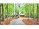 Charming home nestled amongst trees with a private driveway and a two-car garage at 145 Flat Creek Ct, Fayetteville, GA 30214