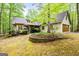 Home showcasing mature landscaping, stone accents, and a convenient two-car garage at 145 Flat Creek Ct, Fayetteville, GA 30214