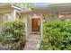Inviting front entrance with stone steps and a wooden door, surrounded by lush greenery at 145 Flat Creek Ct, Fayetteville, GA 30214