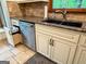 Granite countertop with deep sink and modern faucet, stainless dishwasher, custom cabinet door trash can at 145 Flat Creek Ct, Fayetteville, GA 30214