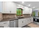 Well-lit kitchen featuring stainless steel dishwasher, stone backsplash, and ample counter space at 145 Flat Creek Ct, Fayetteville, GA 30214