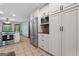 Kitchen showcasing stainless steel appliances, custom cabinetry, and ceramic tile flooring at 145 Flat Creek Ct, Fayetteville, GA 30214