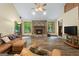 Open living area featuring hardwood floors, a stone fireplace, large windows and natural light at 145 Flat Creek Ct, Fayetteville, GA 30214