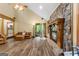 Cozy living room with hardwood floors, stone fireplace, and open access to the outdoor space at 145 Flat Creek Ct, Fayetteville, GA 30214