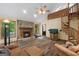 Open-concept living room featuring hardwood floors, a fireplace, spiral staircase, and bright windows at 145 Flat Creek Ct, Fayetteville, GA 30214