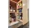Pull-out spice rack in custom wooden kitchen cabinet, adjacent to stone backsplash at 145 Flat Creek Ct, Fayetteville, GA 30214