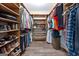A walk-in closet features plenty of shelving and racks for storage at 145 Flat Creek Ct, Fayetteville, GA 30214